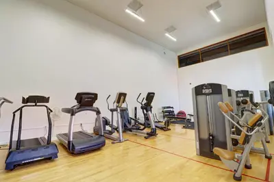 a gym with treadmills and exercise bikes in a room at 727B Meadow Creek townhouse in Frisco