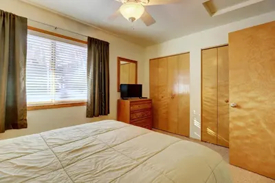 a bedroom with a bed and a tv and a window at 727B Meadow Creek townhouse in Frisco