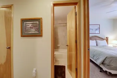 a bedroom with a bed and a bathroom with a tub at 727B Meadow Creek townhouse in Frisco
