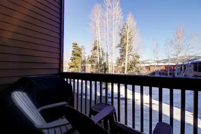 two chairs on a balcony with a view of trees at 727B Meadow Creek townhouse in Frisco
