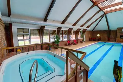 a large swimming pool in a building with an attic at 727B Meadow Creek townhouse in Frisco