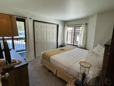 a bedroom with a bed and a large window at Beautiful Renovated 3BR in Keystone condo in Keystone