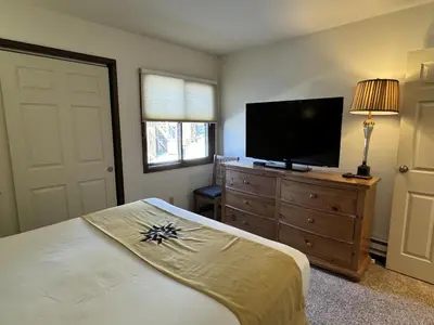 a bedroom with a bed and a flat screen tv at Beautiful Renovated 3BR in Keystone condo in Keystone