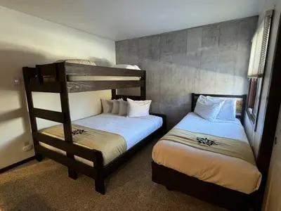 two beds in a room with two bunk beds at Beautiful Renovated 3BR in Keystone condo in Keystone