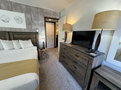 a bedroom with a bed and a flat screen tv at Beautiful Renovated 3BR in Keystone condo in Keystone