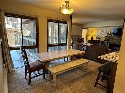 a dining room with a wooden table and chairs at Beautiful Renovated 3BR in Keystone condo in Keystone