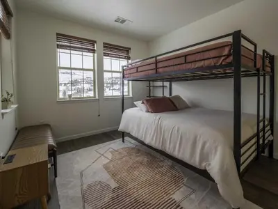a bedroom with two bunk beds and a rug at Aspen Meadows C-302, 0013 in Granby