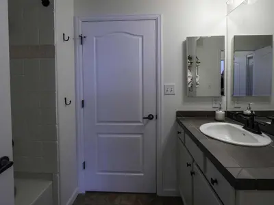 a bathroom with a white door and a sink at Aspen Meadows C-302, 0013 in Granby