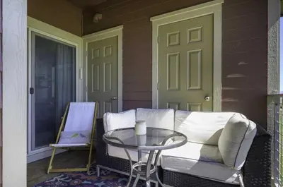a porch with a couch and a glass table at Aspen Meadows C-302, 0013 in Granby