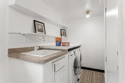 a kitchen with a sink and a washing machine at Cozy Central Aurora Home in Aurora