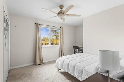 a bedroom with a bed and a window at Cozy Central Aurora Home in Aurora