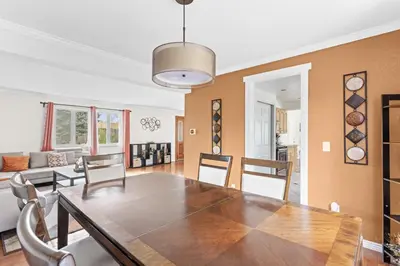 a dining room and living room with a table and chairs at Cozy Central Aurora Home in Aurora