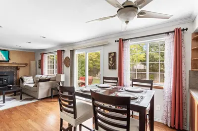 a dining room and living room with a table and chairs at Cozy Central Aurora Home in Aurora