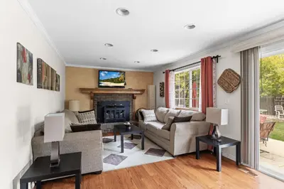 a living room with a couch and a fireplace at Cozy Central Aurora Home in Aurora
