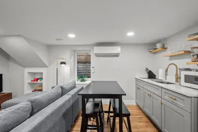 a living room and kitchen with a couch and a table at Downtown Stay off Broadway Nightlife Nearby Parking in Denver
