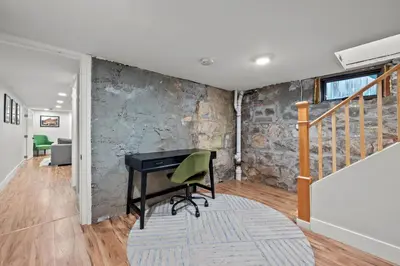 an office with a desk in a room with a stone wall at Downtown Stay off Broadway Nightlife Nearby Parking in Denver
