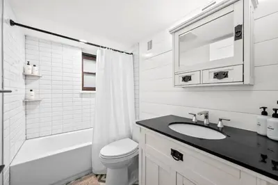 a white bathroom with a sink and a toilet at Downtown Stay off Broadway Nightlife Nearby Parking in Denver