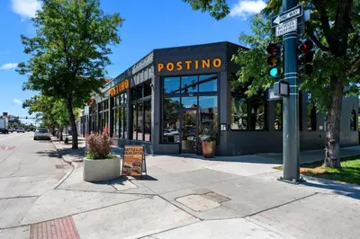 a pole with a street sign in front of a restaurant at Downtown Stay off Broadway Nightlife Nearby Parking in Denver