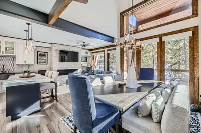 a dining room and living room with a table and chairs at 1890 The Seasons townhouse in Dillon