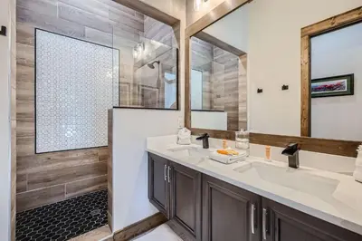 a bathroom with two sinks and a large mirror at 1890 The Seasons townhouse in Dillon