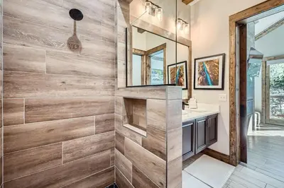 a bathroom with a wooden wall at 1890 The Seasons townhouse in Dillon