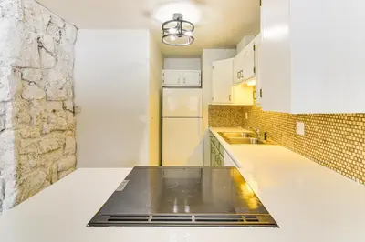 a kitchen with white cabinets and a counter top at Walk to Winter Park Resort Condo with Hot Tub! in Winter Park