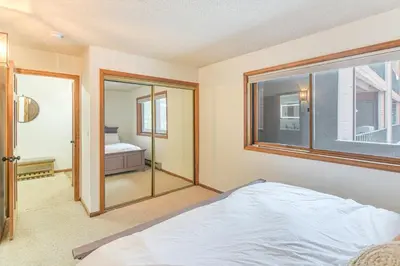 a bedroom with a bed and a window at Walk to Winter Park Resort Condo with Hot Tub! in Winter Park