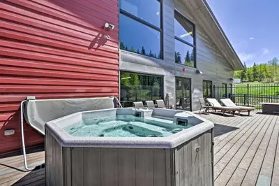 a hot tub on a deck next to a building at Pool and 3 Hot Tubs Winter Park Condo on Bus Line in Winter Park