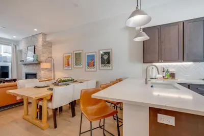 a kitchen with a table and chairs and a kitchen with a sink at Hot Tub and Views Getaway 8 Mi to Keystone Resort! in Silverthorne