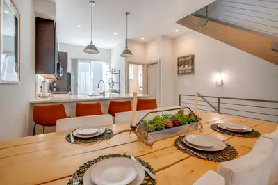 a kitchen and dining room with a wooden table at Hot Tub and Views Getaway 8 Mi to Keystone Resort! in Silverthorne