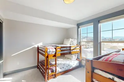 a bedroom with two bunk beds and a window at Mountain Bliss Retreat in Granby in Granby