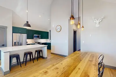 a kitchen with green cabinets and a white counter top at Mountain Bliss Retreat in Granby in Granby