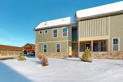 a large building with snow in front of it at Mountain Bliss Retreat in Granby in Granby