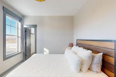 a white bedroom with a large bed with pillows at Mountain Bliss Retreat in Granby in Granby