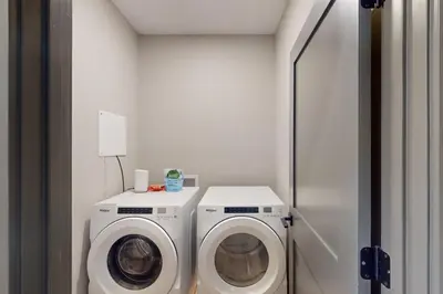 a laundry room with a washer and a washing machine at Mountain Bliss Retreat in Granby in Granby