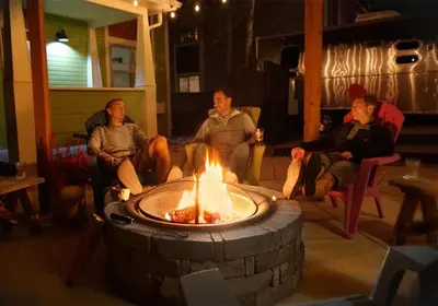 a group of people sitting around a fire pit at Remington Flats in Fort Collins