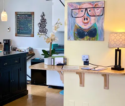 a desk with a painting of a pig wearing a bow tie at Remington Flats in Fort Collins