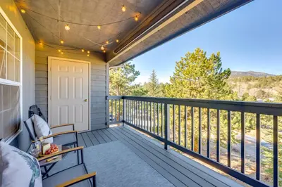 a balcony with chairs and a view of the mountains at Walk to Downtown Mountain-View Estes Escape in Estes Park