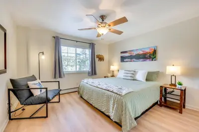 a bedroom with a bed and a ceiling fan at Walk to Downtown Mountain-View Estes Escape in Estes Park