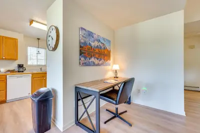 a kitchen with a desk and a clock on a wall at Walk to Downtown Mountain-View Estes Escape in Estes Park