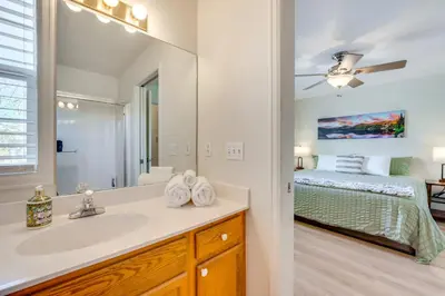 a bathroom with a sink and a bedroom with a bed at Walk to Downtown Mountain-View Estes Escape in Estes Park