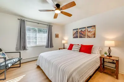 a bedroom with a bed and a ceiling fan at Walk to Downtown Mountain-View Estes Escape in Estes Park
