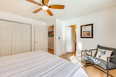 a bedroom with a bed and a ceiling fan at Walk to Downtown Mountain-View Estes Escape in Estes Park