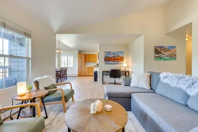 a living room with a couch and a table at Walk to Downtown Mountain-View Estes Escape in Estes Park