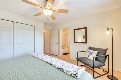 a bedroom with a bed and a chair and a ceiling fan at Walk to Downtown Mountain-View Estes Escape in Estes Park