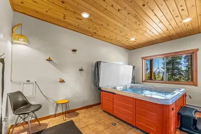 a hot tub in a room with a refrigerator at Tranquil Trails in Granby