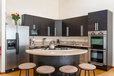 a kitchen with a large island in the middle of a kitchen at Wonderful Mountain Retreat with Fantastic Views in Fraser
