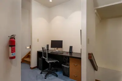 an office with a desk with a computer and a chair at Wonderful Mountain Retreat with Fantastic Views in Fraser
