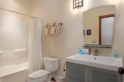 a bathroom with a toilet and a sink and a mirror at Wonderful Mountain Retreat with Fantastic Views in Fraser
