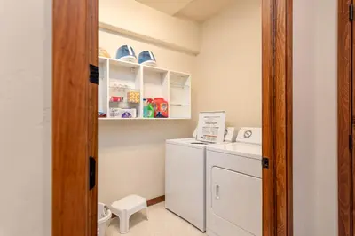 a small laundry room with a washer and dryer at Wonderful Mountain Retreat with Fantastic Views in Fraser